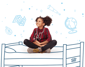 Girl smiling and sitting cross-legged on an animated bed